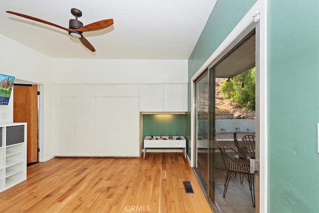 interior space with ceiling fan and light hardwood / wood-style floors