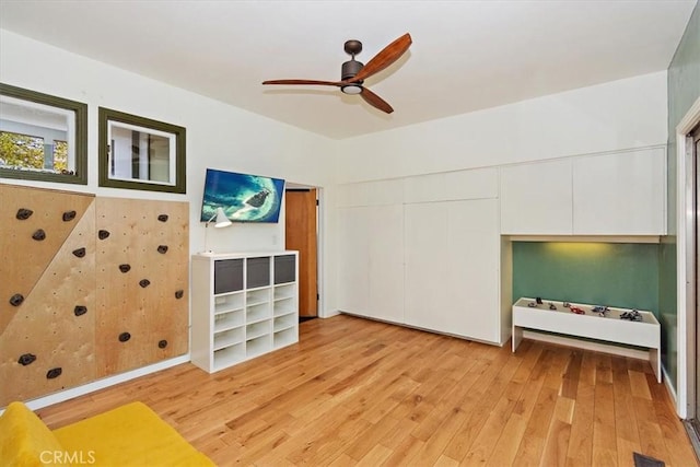 living room with ceiling fan and light wood-type flooring