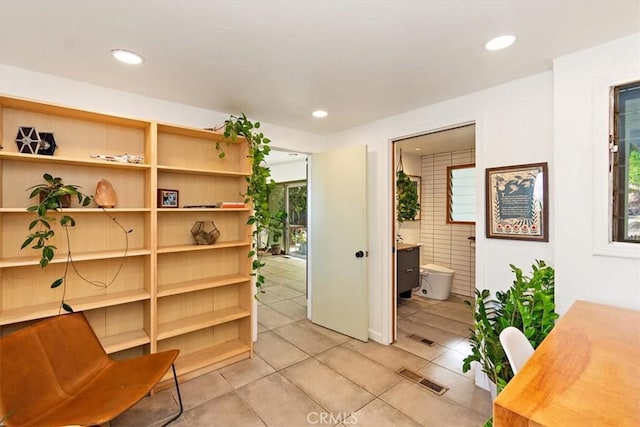 interior space with light tile patterned floors and plenty of natural light