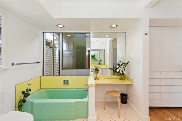 bathroom with a tub to relax in