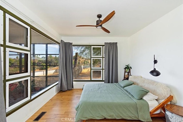 bedroom with ceiling fan and light hardwood / wood-style floors