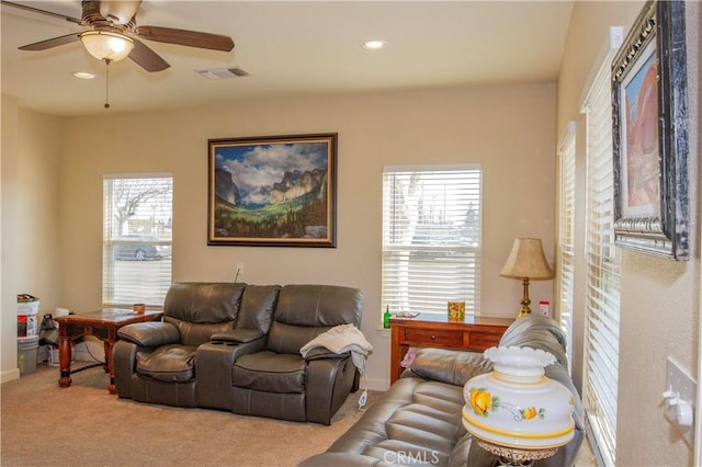 living room with light carpet and ceiling fan