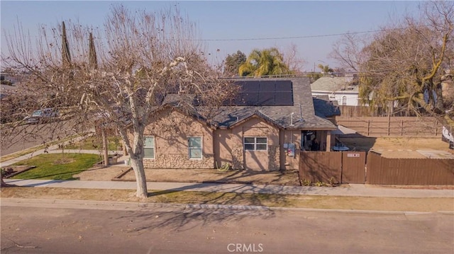 view of front of home featuring solar panels