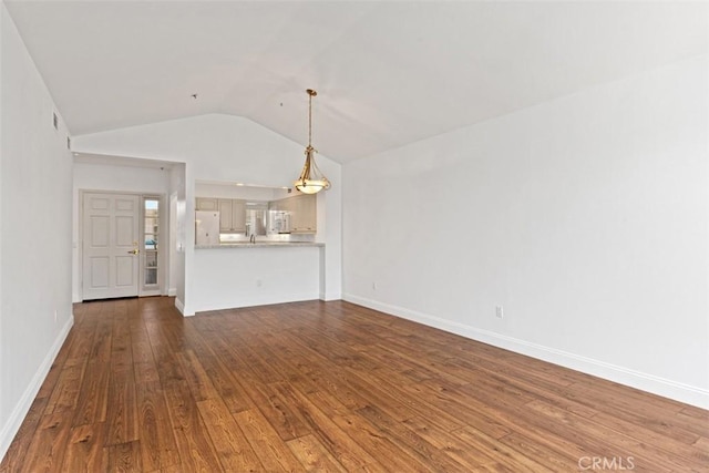 unfurnished living room featuring hardwood / wood-style flooring and lofted ceiling