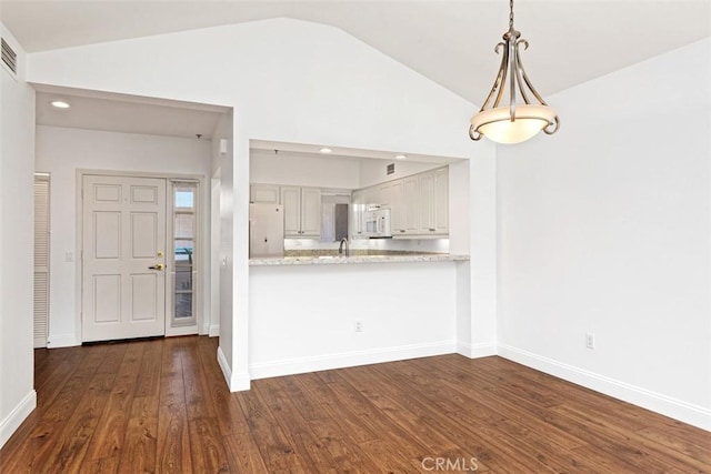 kitchen with dark wood-type flooring, lofted ceiling, white cabinetry, pendant lighting, and white appliances