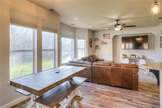 living room featuring hardwood / wood-style floors and ceiling fan