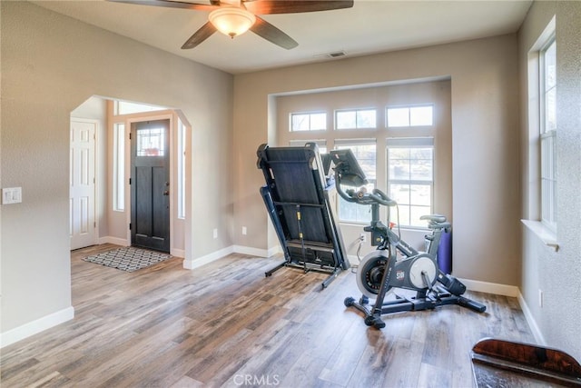 exercise area with light hardwood / wood-style flooring and ceiling fan