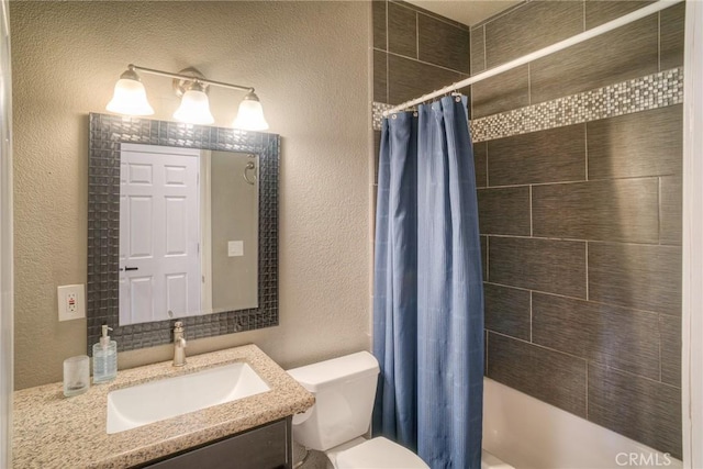 full bathroom with vanity, shower / tub combo, and toilet