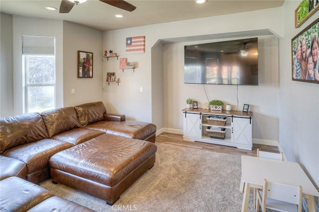 living room featuring hardwood / wood-style flooring and ceiling fan