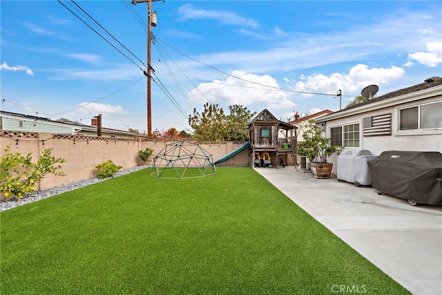 view of yard featuring a patio and a playground