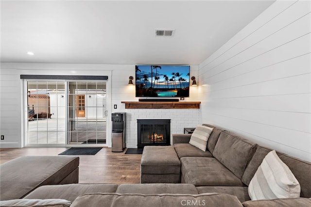 living room with hardwood / wood-style flooring and a fireplace