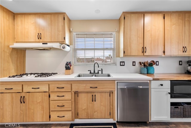 kitchen featuring stainless steel dishwasher, white gas stovetop, light brown cabinetry, and sink