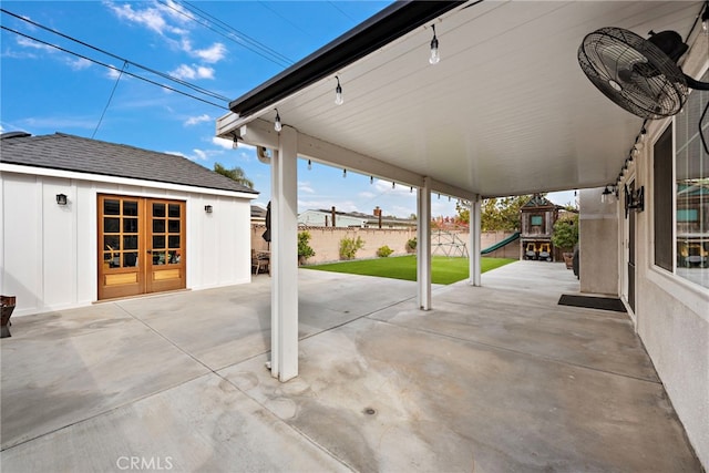 view of patio featuring a playground, an outbuilding, and french doors