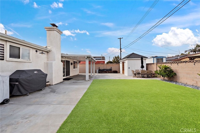 view of yard featuring an outbuilding and a patio area