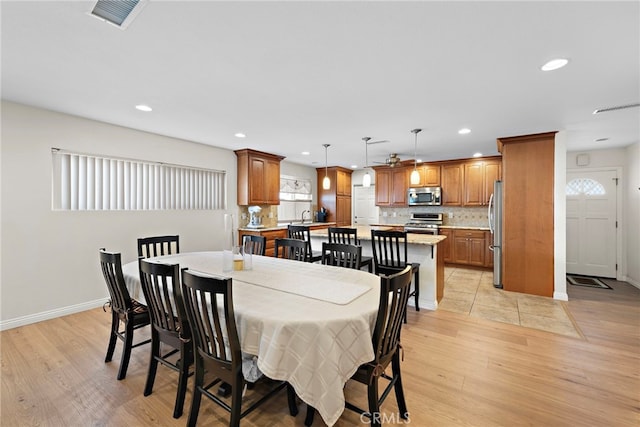 dining space with light hardwood / wood-style floors