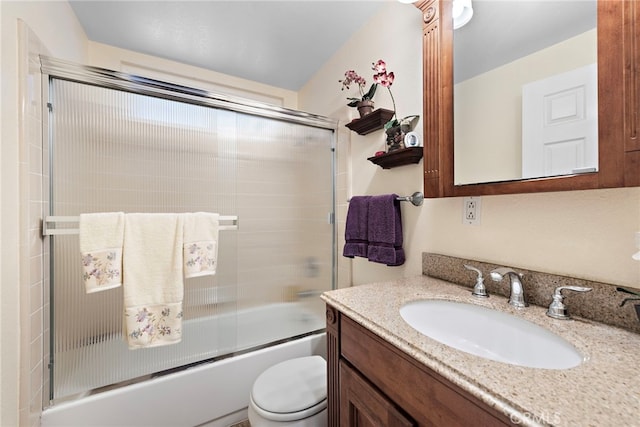 full bathroom featuring enclosed tub / shower combo, vanity, and toilet