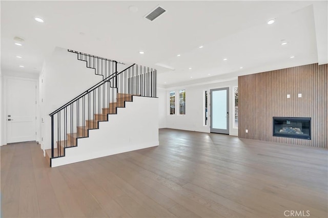 unfurnished living room with hardwood / wood-style flooring