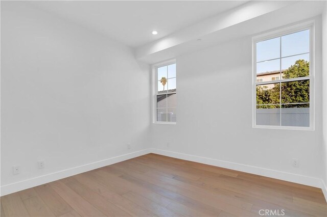 spare room featuring light wood-type flooring