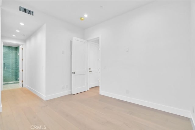 unfurnished room with light wood-type flooring