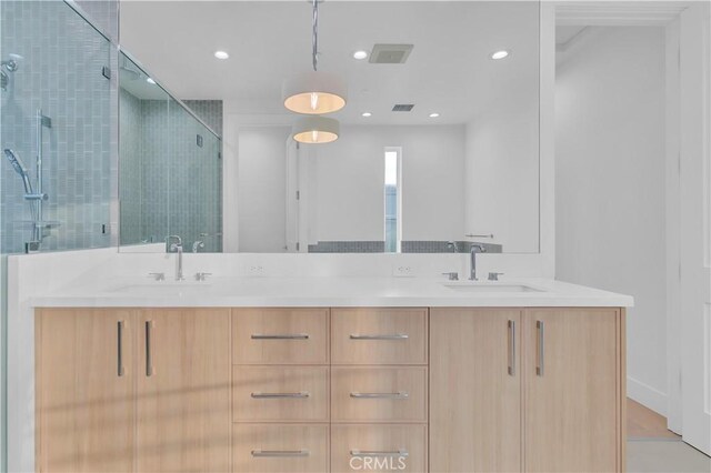 bathroom with vanity and an enclosed shower