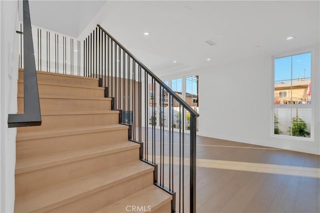 stairs featuring hardwood / wood-style flooring