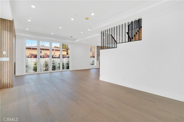 unfurnished living room with hardwood / wood-style flooring