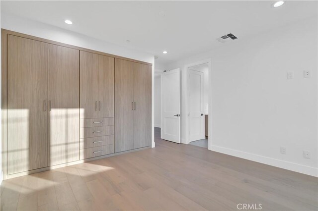 unfurnished bedroom with wood-type flooring