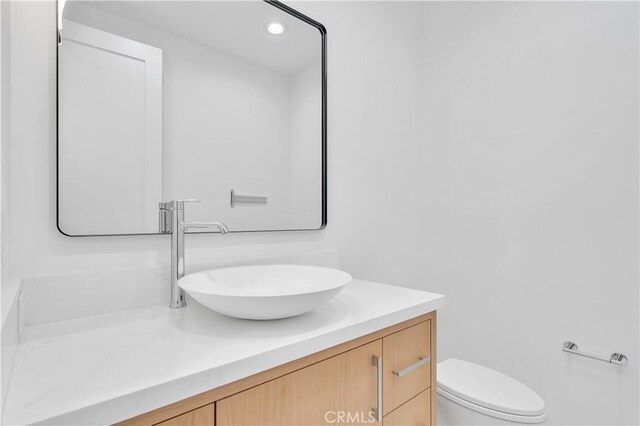 bathroom with vanity and toilet