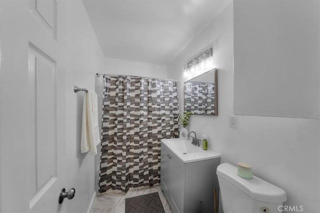 bathroom featuring a shower with shower curtain, toilet, vanity, and marble finish floor