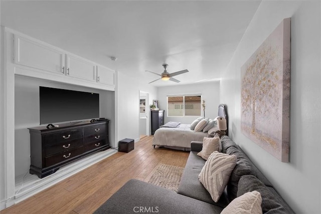 bedroom with ceiling fan and light hardwood / wood-style floors