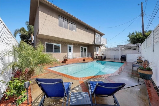 view of swimming pool featuring a patio area, a fenced backyard, and a fenced in pool