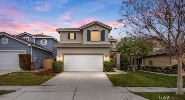 view of front of property featuring a garage and a lawn