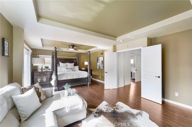 bedroom featuring dark hardwood / wood-style floors and a tray ceiling