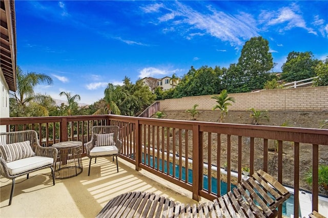 wooden terrace with a fenced in pool