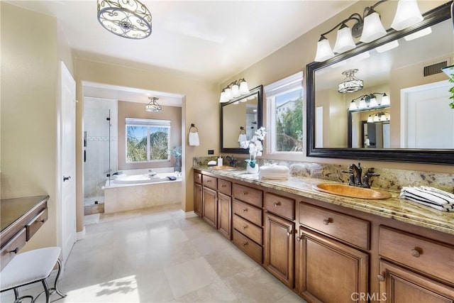 bathroom featuring vanity and separate shower and tub