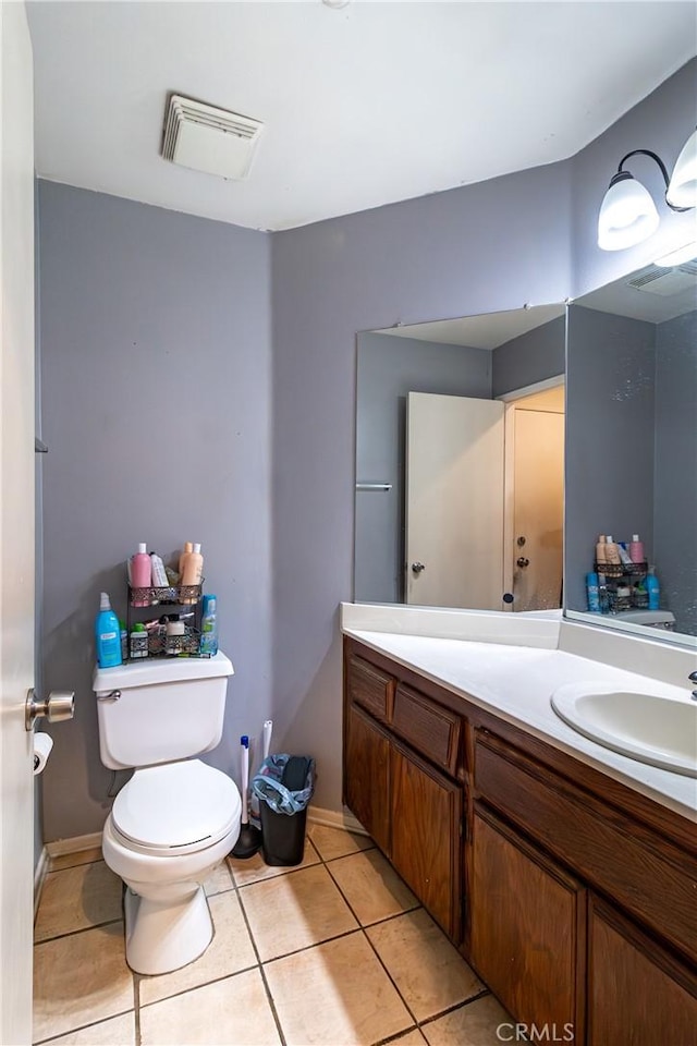 bathroom featuring tile patterned floors, vanity, and toilet