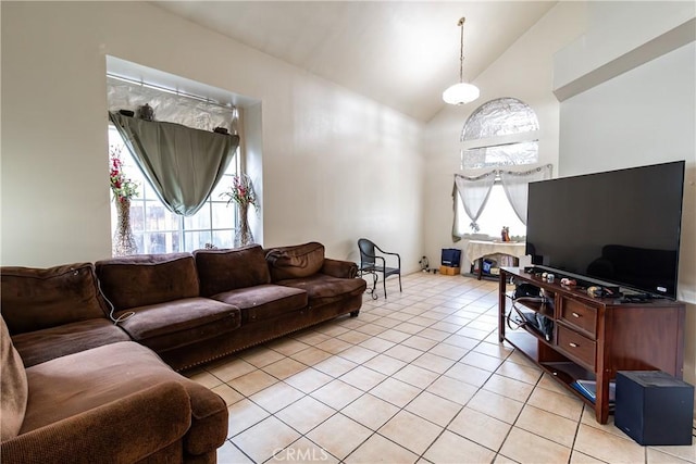 living room featuring high vaulted ceiling and light tile patterned flooring