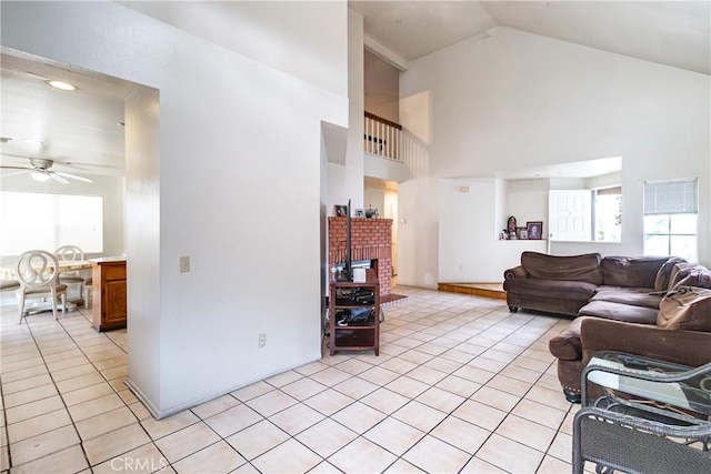 tiled living room featuring high vaulted ceiling and ceiling fan