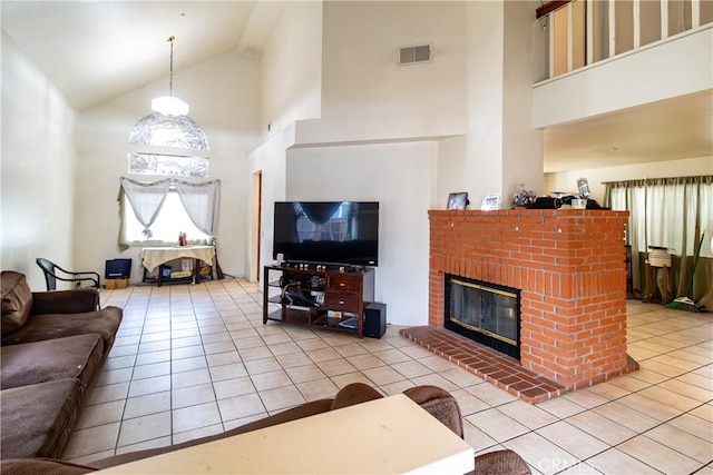 living room featuring high vaulted ceiling, a brick fireplace, and light tile patterned floors