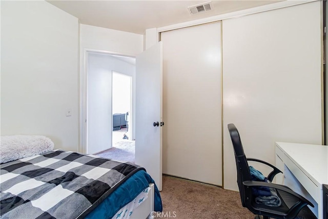 carpeted bedroom featuring a closet