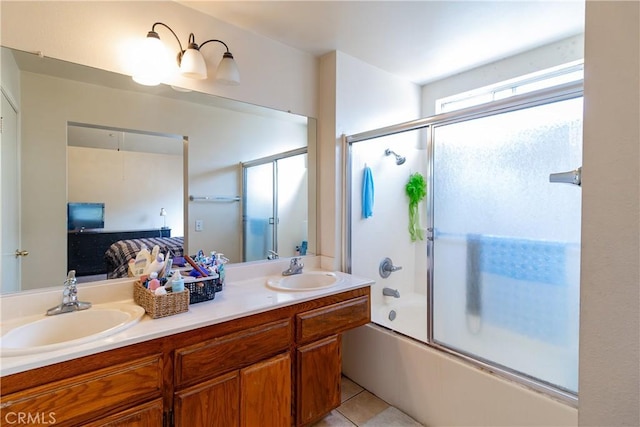 bathroom featuring bath / shower combo with glass door, tile patterned floors, and vanity