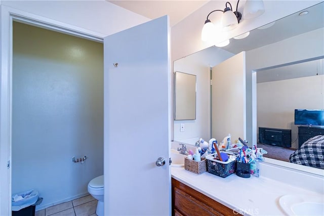 bathroom featuring vanity, tile patterned floors, and toilet