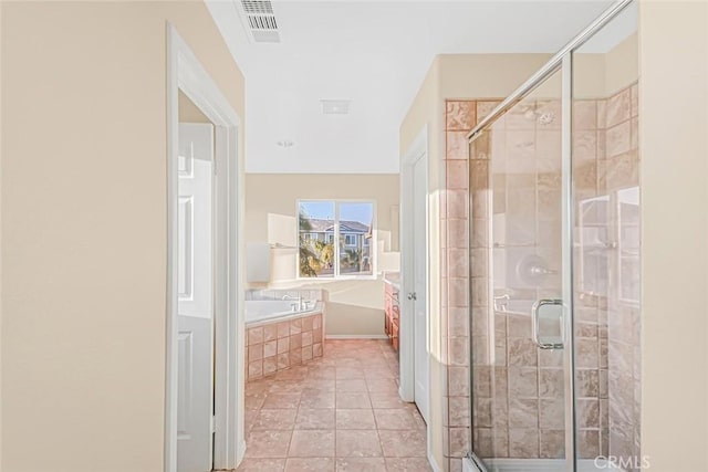 bathroom with tile patterned floors and shower with separate bathtub