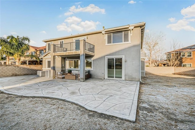 back of house with a balcony and a patio