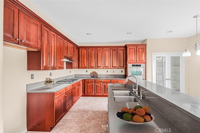 kitchen featuring pendant lighting, sink, light tile patterned floors, and appliances with stainless steel finishes