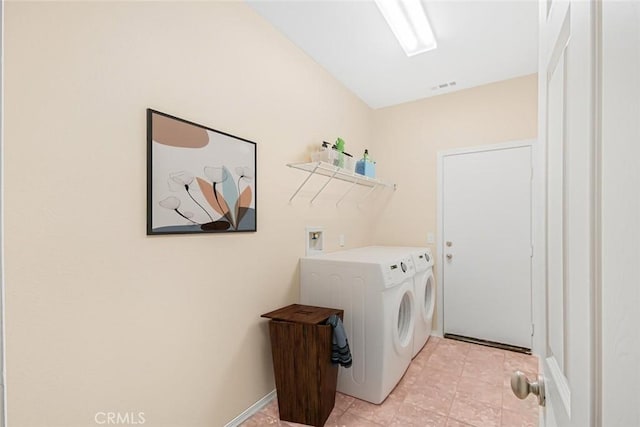 clothes washing area featuring separate washer and dryer