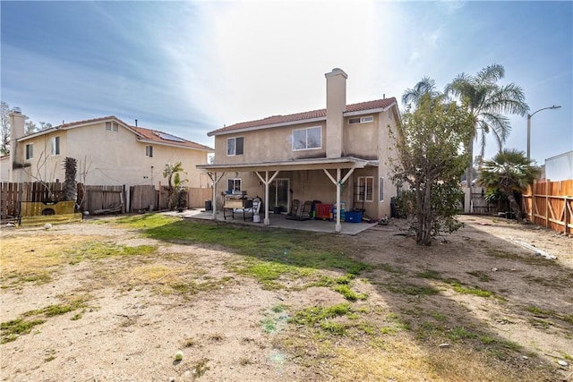 back of property featuring a patio area