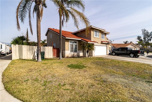 view of property with a garage and a front lawn