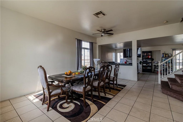 tiled dining space featuring ceiling fan