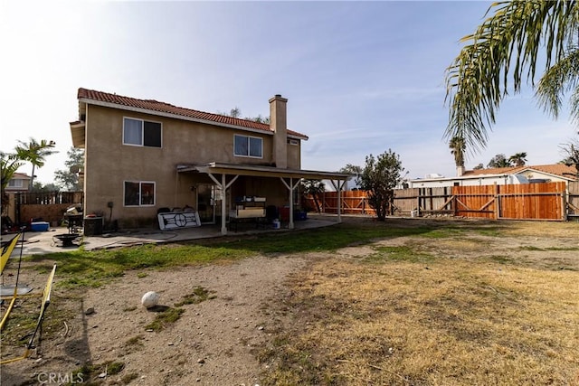 back of property with a patio and a lawn